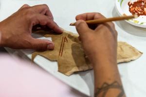 Photo of hand painting a leather hide